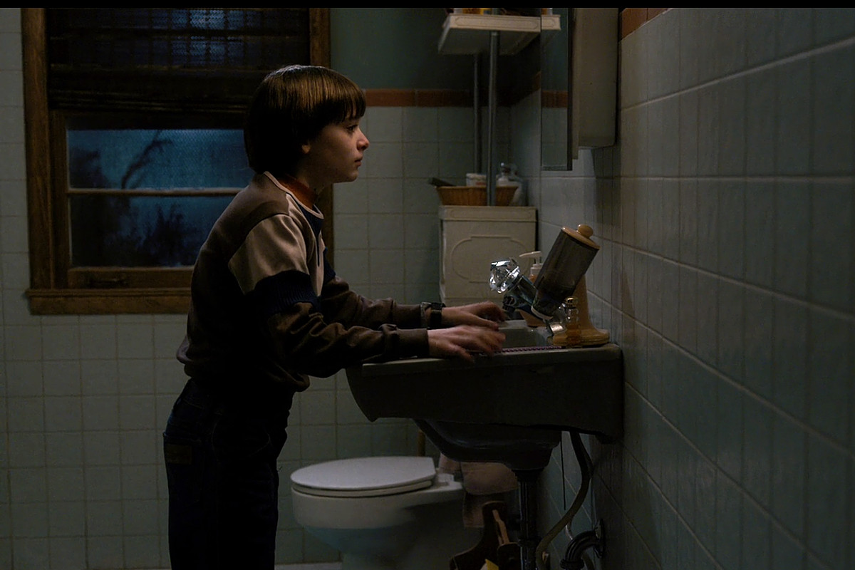 Boy standing in bathroom